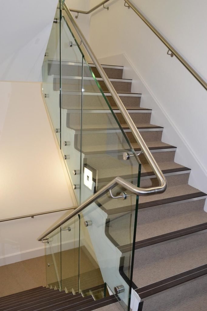 Modern glass stair railing with stainless steel handrail